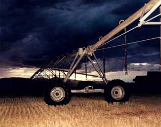 A crop machine under stormy clouds