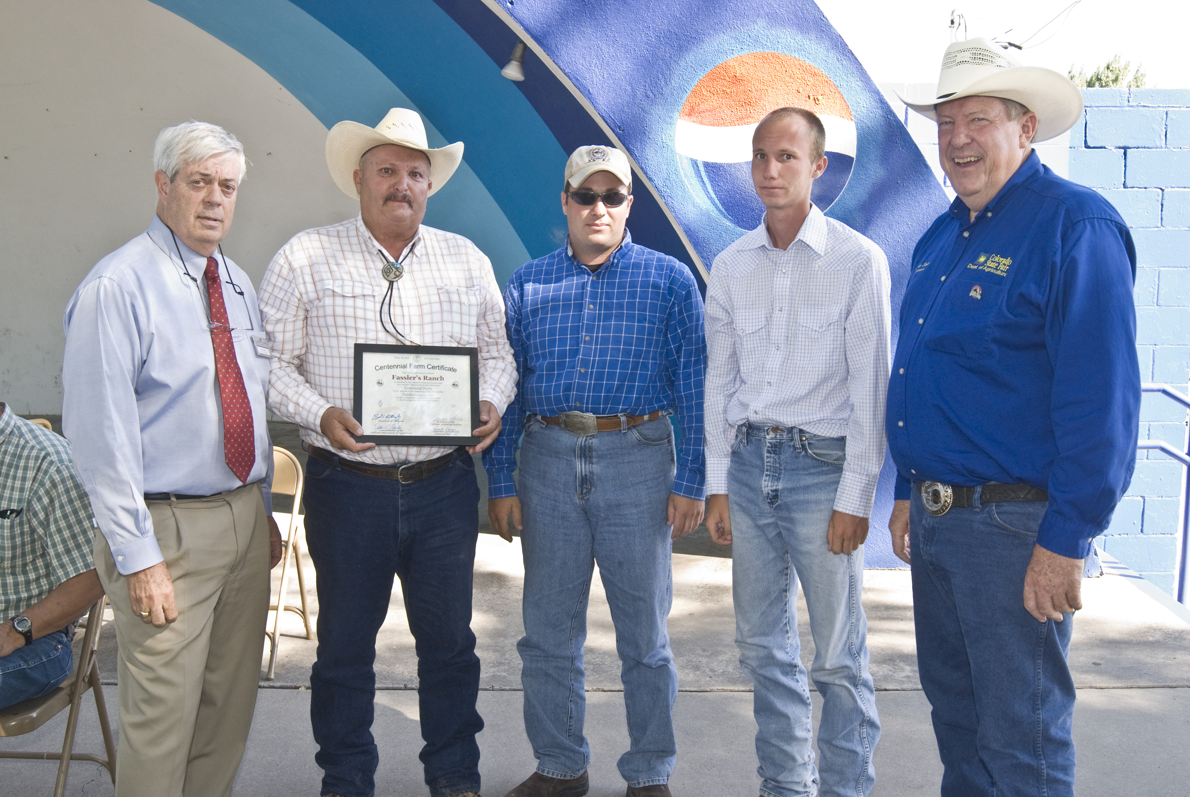 Five men pose together with a Centennial Farms and Ranches Certificate