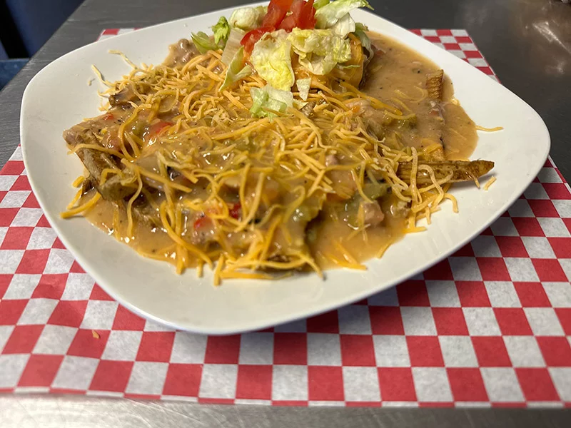 Somwhere beneath all that green chile and cheese is a hamburger and a bun