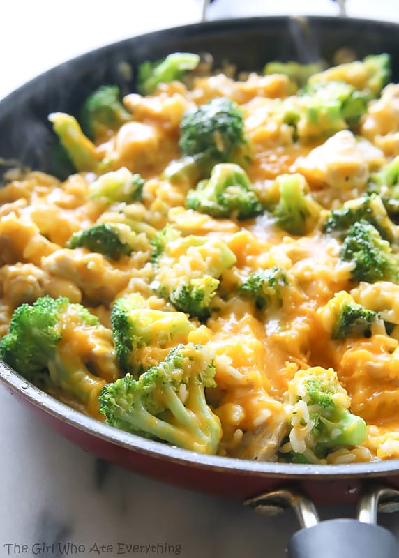 A skillet full or rice, chicken and broccoli, covered in delicious melted cheese