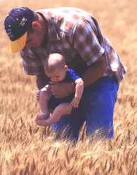 Father and baby in a field