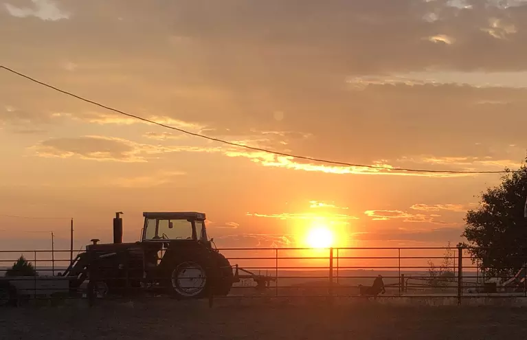 Image of sunset and tractor 